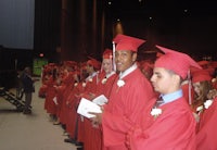 a group of men in red robes standing in a line