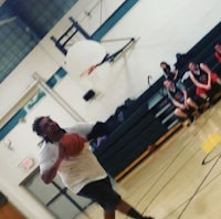 a man dribbling a basketball in a gym