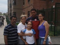 a family posing for a picture in front of a building