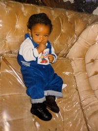 a baby sitting on a couch