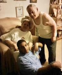 three people are posing for a picture in a living room