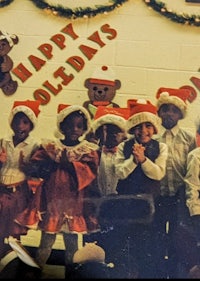 a group of children in santa hats posing for a photo