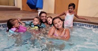 a group of children in a swimming pool